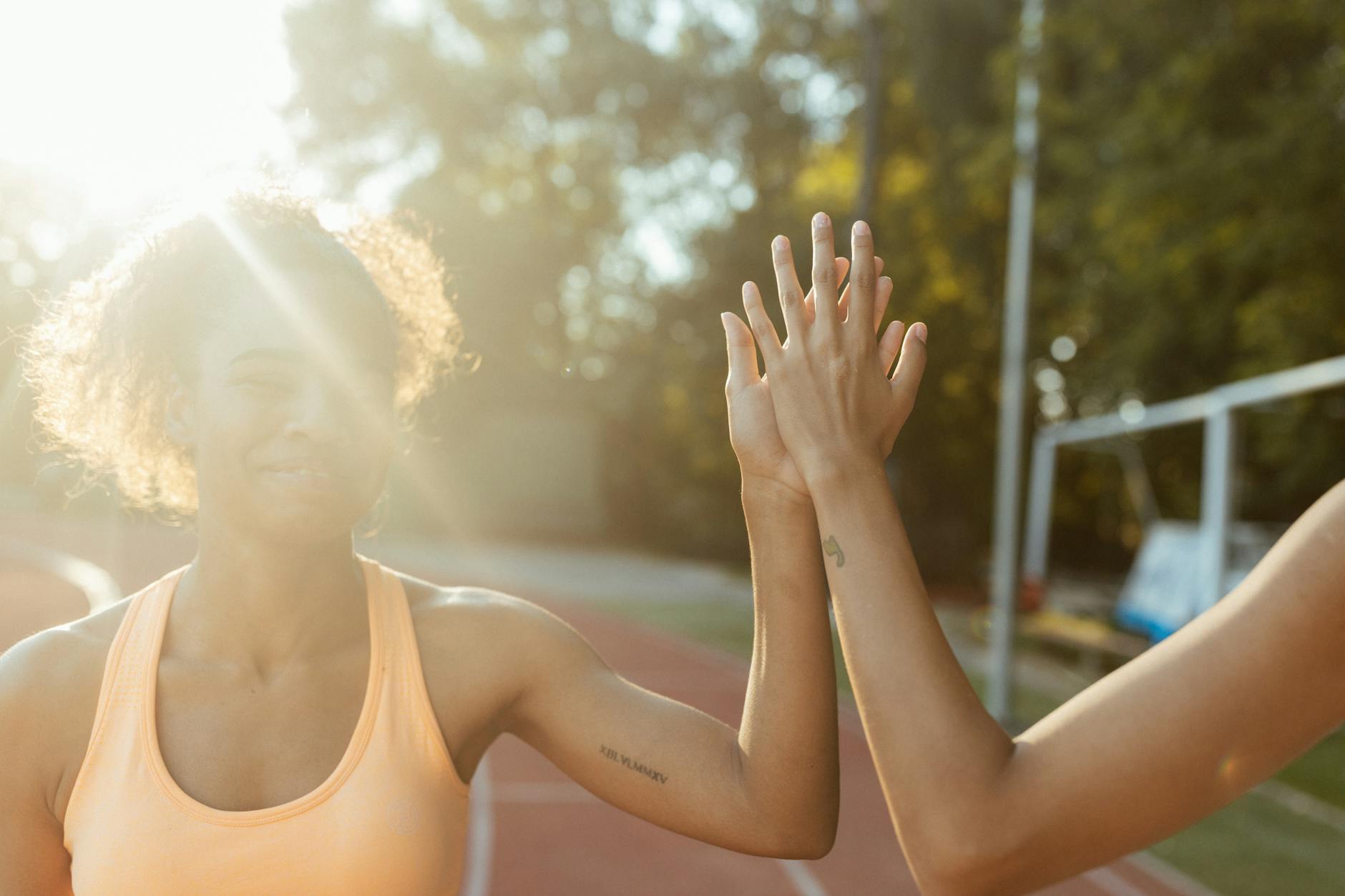 Women celebrating fitness achievement outdoors