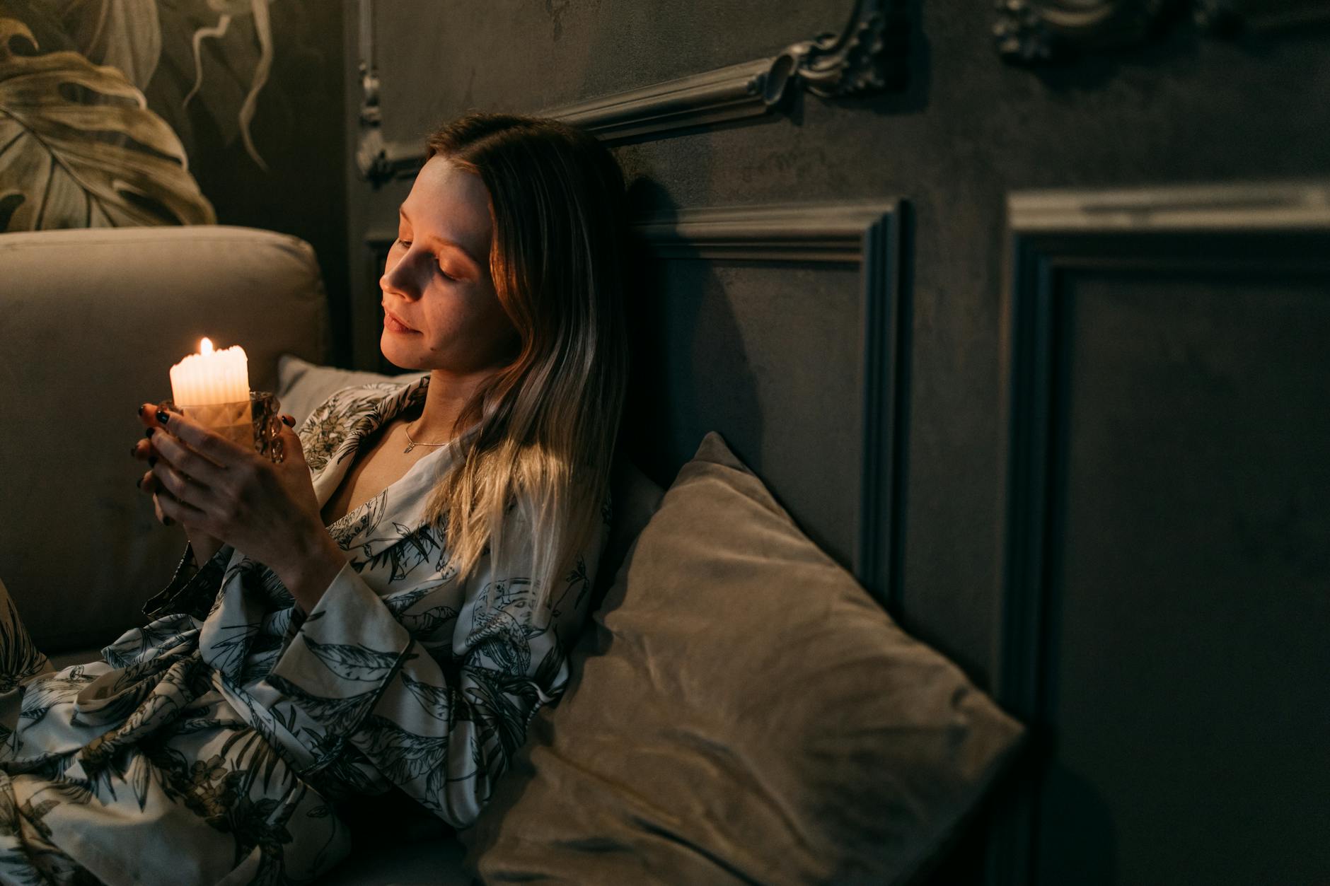 Woman in peaceful morning ritual with candle light